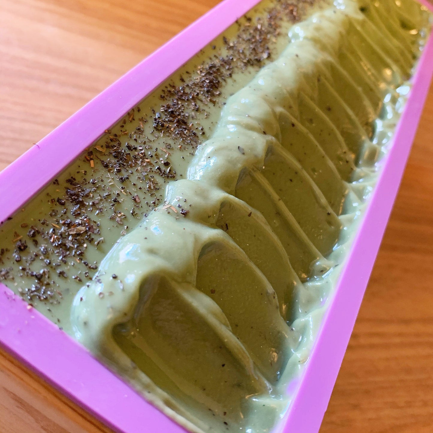 Thistle Soapery Handmade Vegan Soap. Solid green soap bar speckled with tea leaves for a light exfoliating effect. Wrapped in a recycled kraft paper sleeve.