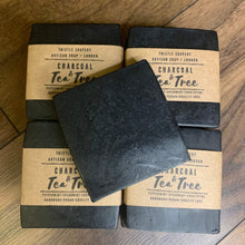 Load image into Gallery viewer, Thistle Soapery Handmade Vegan Facial Soap. Solid black charcoal soap bar. Wrapped in a recycled kraft paper sleeve.
