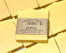 Load image into Gallery viewer, Yellow soap bar with a label on a yellow background
