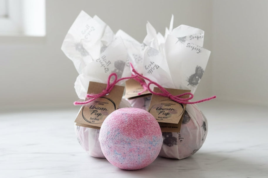 Pink and purple swirled bath bombs with beautifully wrapped bath bombs in the background 