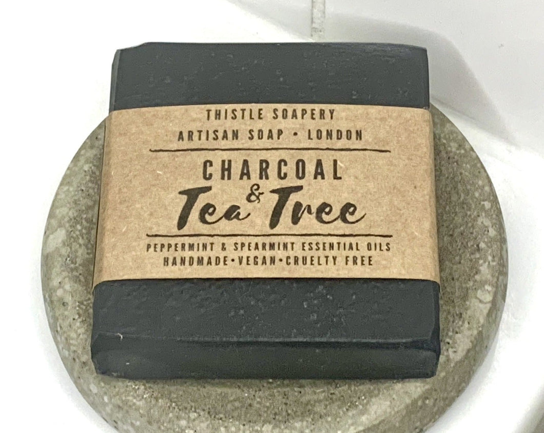Thistle Soapery Handmade Vegan Facial  Soap. Solid black charcoal soap bar. Wrapped in a recycled kraft paper sleeve.