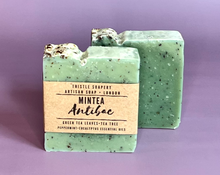 Load image into Gallery viewer, Green mintea soap with green tea and essential oils on purple background 
