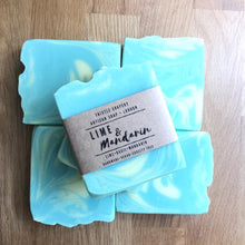 Load image into Gallery viewer, Thistle Soapery Handmade Vegan Soap. Solid green soap bar with green and yellow swirls. Wrapped in a recycled kraft paper sleeve.
